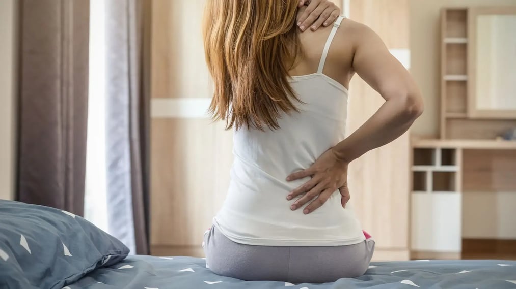 Close up of woman in beige underwear conducting a self-examination of her breast