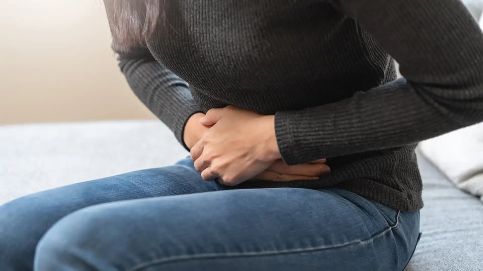 close up woman suffering stomach pain-1